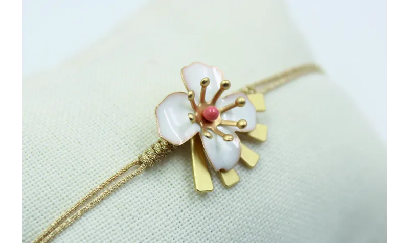 Pulsera nudo serpiente en color oro palido con flo