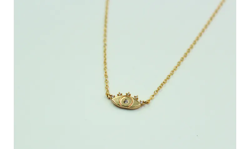 Solitario ojo turco con brillos de cristal en lató