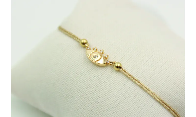 Pulsera de macrame en color oro palido y ojo turco