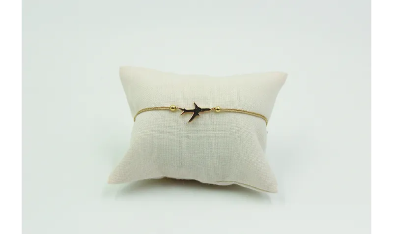 Pulsera de macrame en color oro palido y avión dor