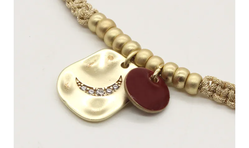 Pulsera macrame oro palido con bolas oro mate y co