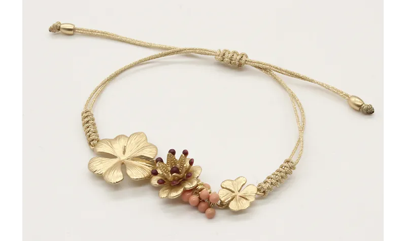 Pulsera nudo serpiente oro palido con trio de flor