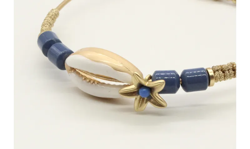 Pulsera rigida con macrame dorado palido, caracola