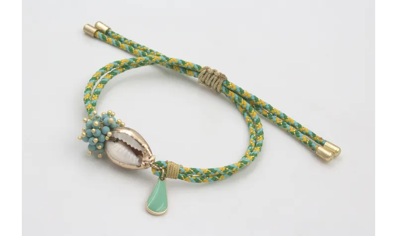 Pulsera de driza verde y turquesa con burruño bola