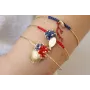 Pulsera rigida dorada brillo con nudo macramé azul