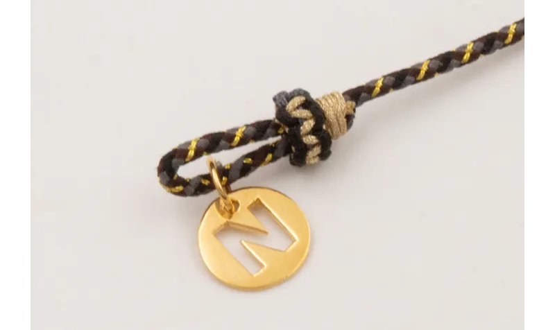 Pulsera driza negra,dorada,gris con nudo falso mac