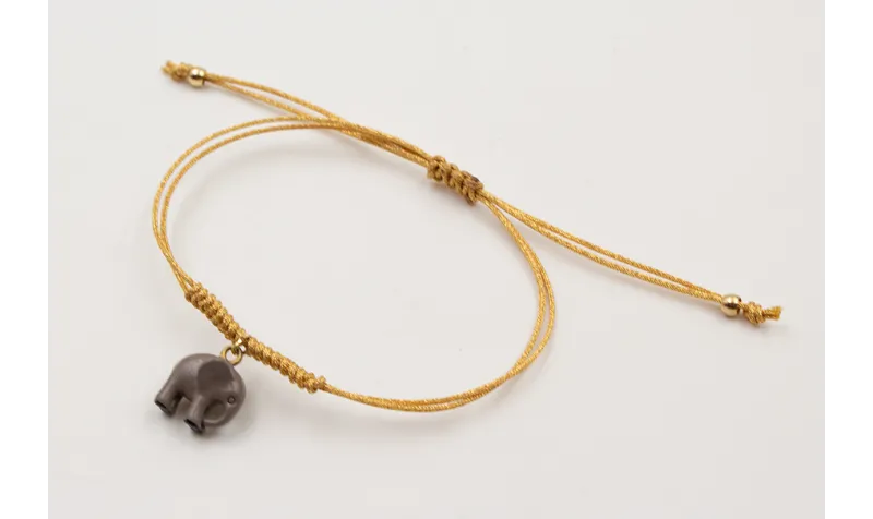 Pulsera hilo metálico dorado con nudo serpiente y 