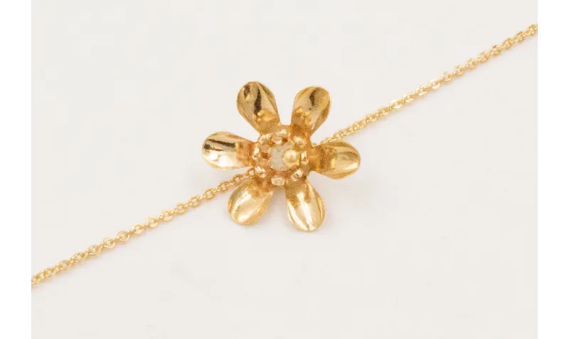 Pulsera ORO 18K. Cadena eslabón pequeño con flor y
