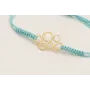 Pulsera hilo azul claro con pieza 6 aros dorada ma