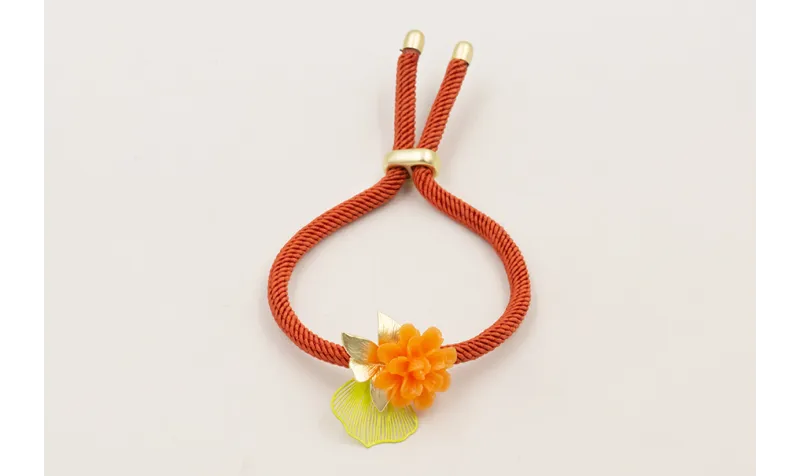 Pulsera cordón color oxido con centro flor resina 
